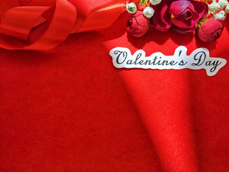 Valentine's Day concept celebration, congratulation. Red greeting Card with flower, Satin ribbon for Background, texture, place for text, copy space