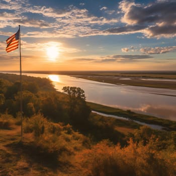 Memorial Day: Aerial view of sunset over the river and the American flag.