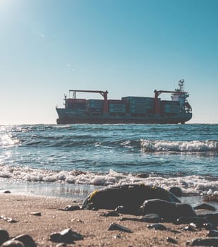 Container cargo ship stands aground after a storm.