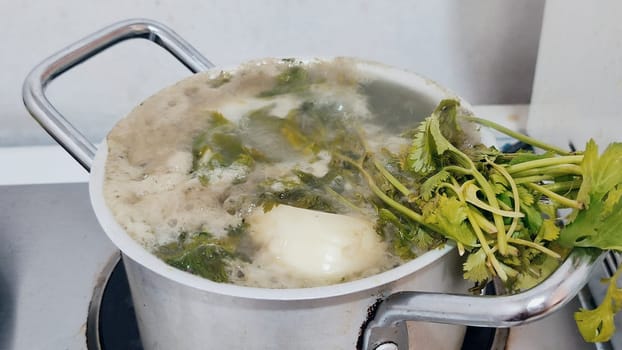 soup broth with parsley in aluminum pan, food lunch dish kitchen cooking. High quality photo