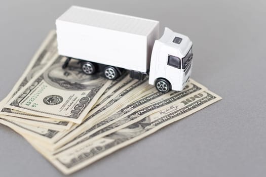 Toy car truck with money isolated on white background. High quality photo