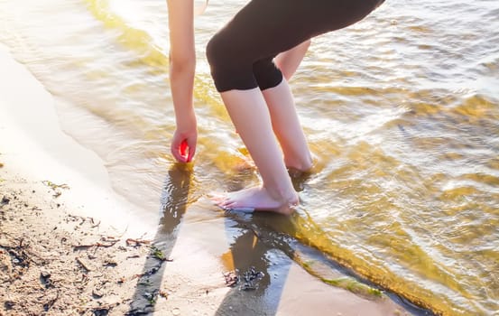 Child's bare feet walking at a beach.