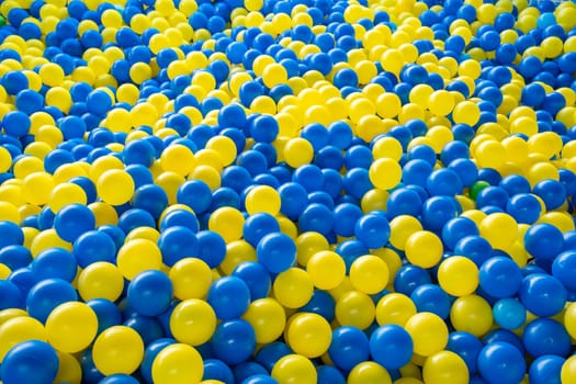 Top view of many colorful balls in ball pool at indoors playground. High quality photo
