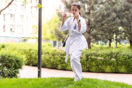 young girl in a white kimono, karate. High quality photo