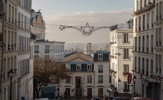 France, Paris - Jan 03, 2024 - Paris city view from the butte of Montmartre streets with Christmas stars decoration led lights display. Paris Buildings. Space for text, Selective focus.