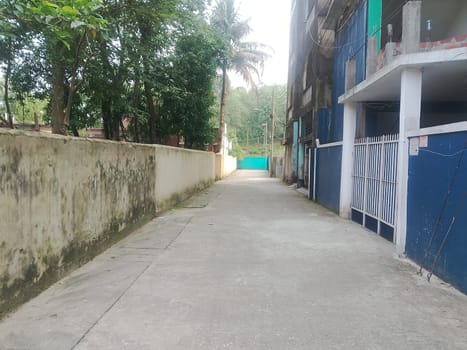 A walkway between buildings with trees. High quality photo