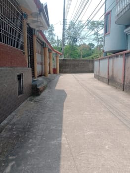 A street with a brick wall and a fence. High quality photo