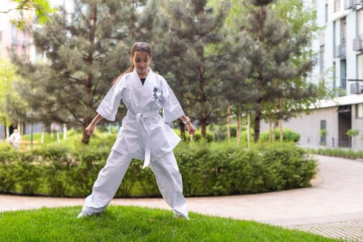 young girl in a white kimono, karate. High quality photo