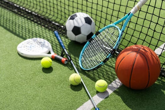 A group of sports equipment on background including tennis, basketball, and soccer on a background with copy space. High quality photo