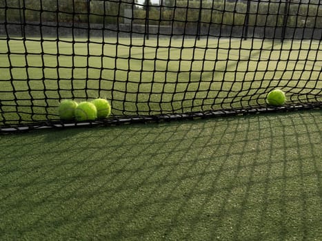 Tennis balls are on green grass. High quality photo