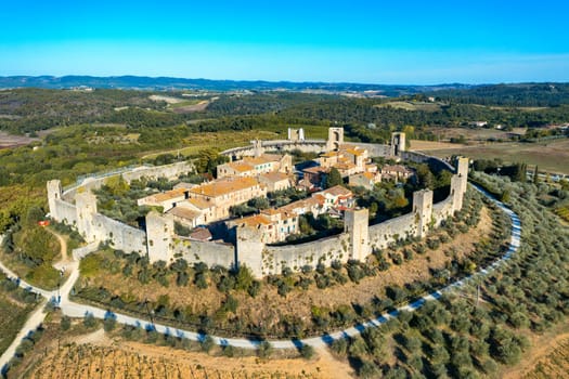 Beautiul aerial view of Monteriggioni, Tuscany medieval town on the hill. Tuscan scenic landscape vista with ancient walled city Monteriggioni, Italy.