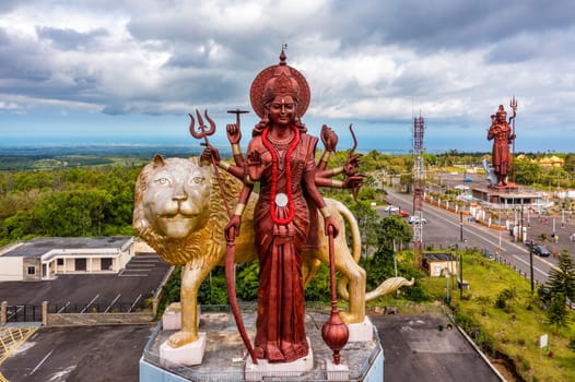 A powerful Statue of the Hindu goddess Durga Maa with a golden lion in sacred Ganga Talao. Shiva statue at Grand Bassin temple, the world's tallest Shiva temple, it is 33 meters tall. Mauritius