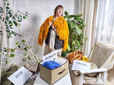 Middle-Aged Woman Sorting Belongings With KonMari Method. Mature woman categorizes items into keep and discard piles