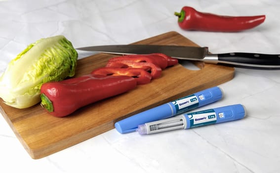 Original Danish Ozempic Insulin injection pen for diabetics and vegetables. Denmark - May 2, 2024