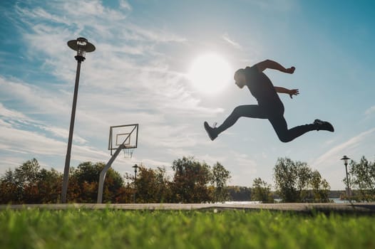 Caucasian man jumping with high hip raise outdoors
