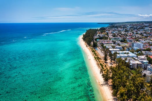 Beautiful Mauritius island with beach Flic en flac. Coral reef around tropical palm beach, Flic en Flac, Mauritius. Aerial view of a beautiful beach along the coast in Flic en Flac, Mauritius.