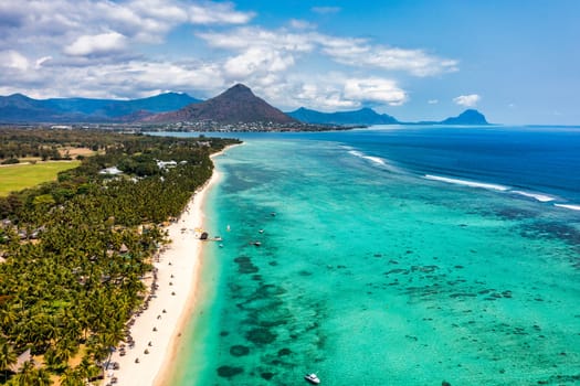 Beach of Flic en Flac with beautiful peaks in the background, Mauritius. Beautiful Mauritius Island with gorgeous beach Flic en Flac, aerial view from drone. Flic en Flac Beach, Mauritius Island.