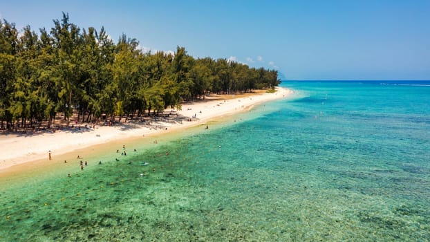 Beach of Flic en Flac with Piton de la Petite Riviere Noire Mauritius. Beautiful Mauritius Island with gorgeous beach Flic en Flac, aerial view from drone. Flic en Flac Beach, Mauritius Island.