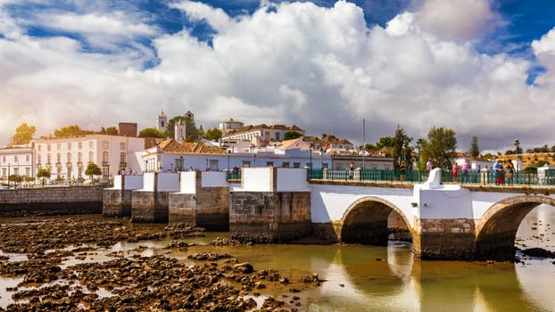 View of the city of Tavira, charming architecture of Tavira, Algarve, Portugal. Santiago of Tavira church in the old town of the beautiful city of Tavira in a sunny day. Algarve region, Portugal