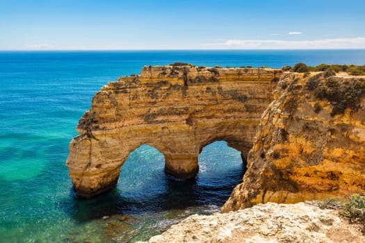 Praia da Marinha, beautiful beach Marinha in Algarve, Portugal. Navy Beach (Praia da Marinha) with flying seagulls over the beach, located on the Atlantic coast in Lagoa Municipality, Algarve.