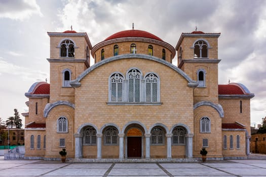 A large, ornate building with a red roof and white trim. The building is a church with a dome on top. Nicosia, Cyprus.