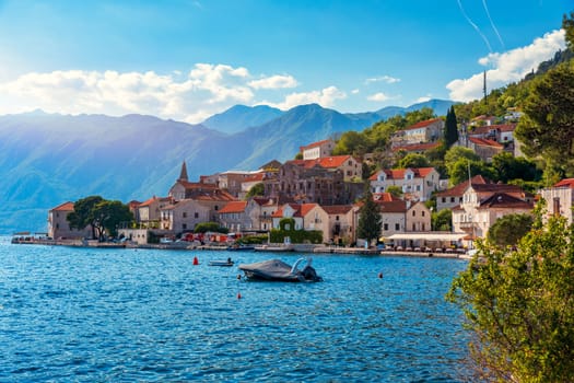 View of the historic town of Perast at famous Bay of Kotor on a beautiful sunny day with blue sky and clouds in summer, Montenegro. Historic city of Perast at Bay of Kotor in summer, Montenegro.