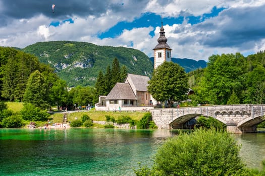 Aerial view of Bohinj lake in Julian Alps. Popular touristic destination in Slovenia. Bohinj Lake, Church of St John the Baptist. Triglav National Park, Julian Alps, Slovenia. 