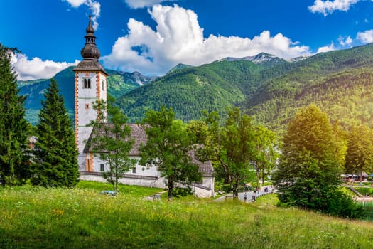 Aerial view of Bohinj lake in Julian Alps. Popular touristic destination in Slovenia. Bohinj Lake, Church of St John the Baptist. Triglav National Park, Julian Alps, Slovenia. 