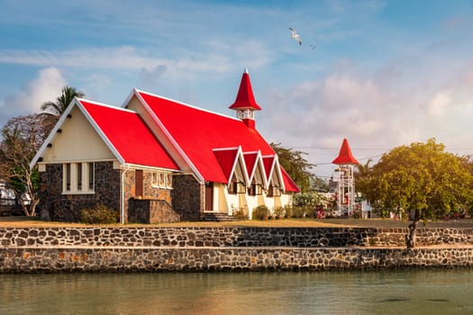 Red church at Cap Malheureux village, Mauritius Island. Notre Dame de Auxiliatrice, rural church with red roof in Cap Malheureux tropical village on Mauritius island, Indian Ocean.