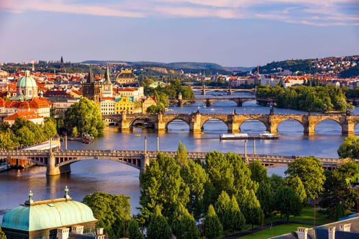 Scenic view of the Old Town pier architecture and Charles Bridge over Vltava river in Prague, Czech Republic. Prague iconic Charles Bridge (Karluv Most) and Old Town Bridge Tower at sunset, Czechia.