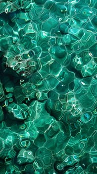 A closeup of an azure liquid surface with rocks in the background, showcasing a beautiful pattern of electric blue hues. It gives a glimpse of marine biology organisms underwater