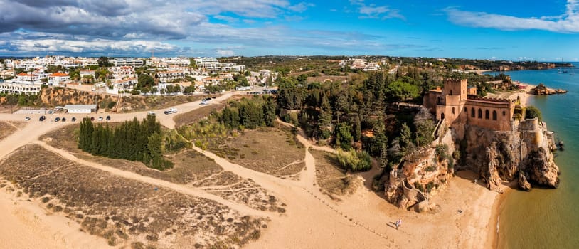 View of Ferragudo village in Algarve, Portugal. Old sea town of Ferragudo. View of Ferragudo from the air. Ferragudo is a beautiful coastal village in Algarve, Portugal, Europe.