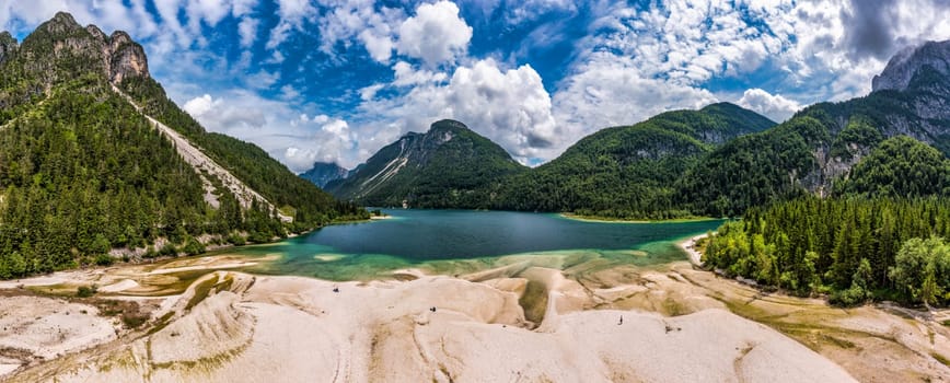 View to Julian Alps mountains above Predil lake in Italy with small lake. Predil Lake, Friuli Italy / (Lago del Predil), beautiful alpine lake in north Italy near the Slovenian border, Italy.