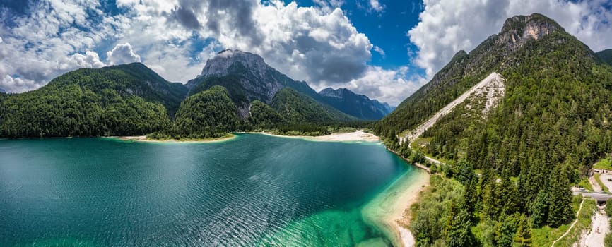 View to Julian Alps mountains above Predil lake in Italy with small lake. Predil Lake, Friuli Italy / (Lago del Predil), beautiful alpine lake in north Italy near the Slovenian border, Italy.