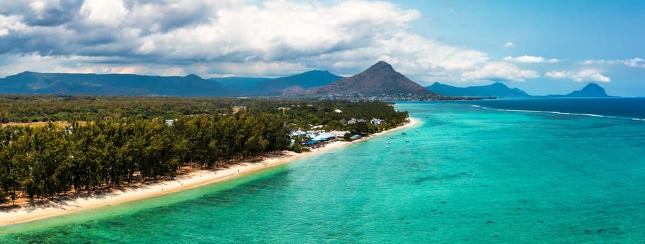 Mauritius, Black River, Flic-en-Flac, Aerial view of coastal beach in summer with Tourelle du Tamarin mountain in distant background. Mauritius island with gorgeous beach Flic en flac.