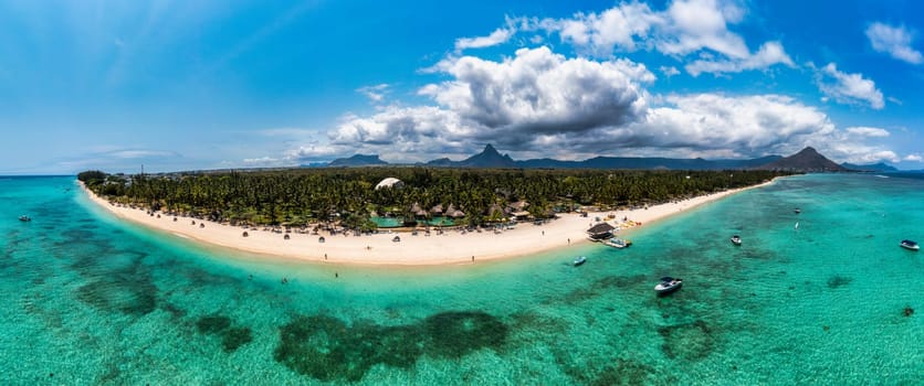 Mauritius, Black River, Flic-en-Flac, Aerial view of coastal beach in summer with Tourelle du Tamarin mountain in distant background. Mauritius island with gorgeous beach Flic en flac.