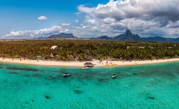 Beautiful Mauritius Island with gorgeous beach Flic en Flac, aerial view from drone. Mauritius, Black River, Flic-en-Flac view of oceanside village beach and luxurious hotel in summer.