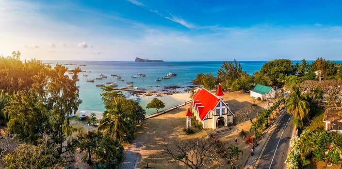 Red church at Cap Malheureux village, Mauritius Island. Notre Dame de Auxiliatrice, rural church with red roof in Cap Malheureux tropical village on Mauritius island, Indian Ocean.