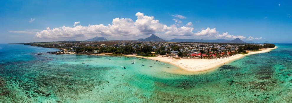 Beautiful Mauritius Island with gorgeous beach Flic en Flac, aerial view from drone. Mauritius, Black River, Flic-en-Flac view of oceanside village beach and luxurious hotel in summer.