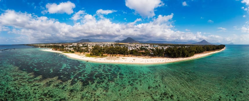 Beautiful Mauritius Island with gorgeous beach Flic en Flac, aerial view from drone. Mauritius, Black River, Flic-en-Flac view of oceanside village beach and luxurious hotel in summer.