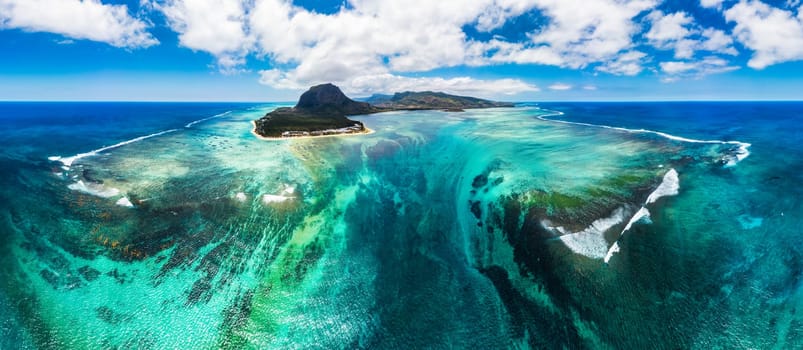 Aerial view of Mauritius island panorama and famous Le Morne Brabant mountain, beautiful blue lagoon and underwater waterfall. Le Morne Brabant peninsula and Underwater Waterfall, Mauritius.