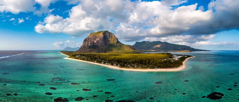 Aerial view of Le morne Brabant in Mauriutius. Tropical crystal ocean with Le Morne mountain and luxury beach in Mauritius. Le Morne beach with palm trees, white sand and luxury resorts, Mauritius.