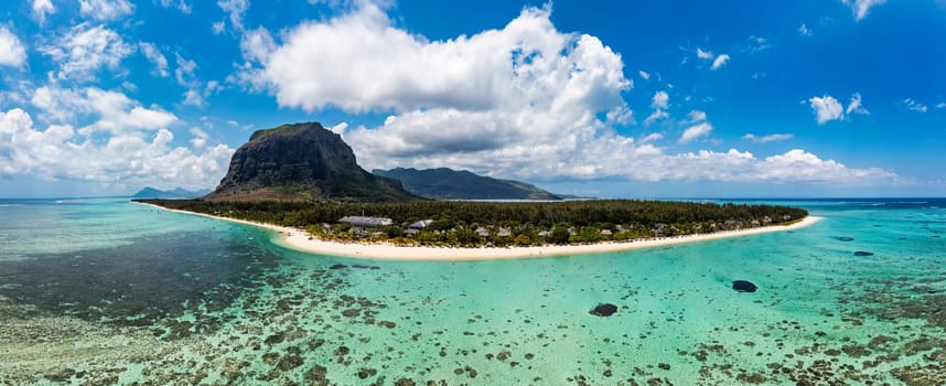 Aerial view of Le morne Brabant in Mauriutius. Tropical crystal ocean with Le Morne mountain and luxury beach in Mauritius. Le Morne beach with palm trees, white sand and luxury resorts, Mauritius.