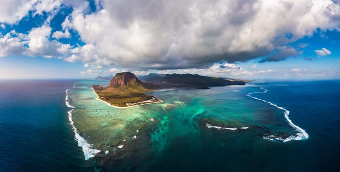 Aerial view of Mauritius island panorama and famous Le Morne Brabant mountain, beautiful blue lagoon and underwater waterfall. Le Morne Brabant peninsula and Underwater Waterfall, Mauritius.