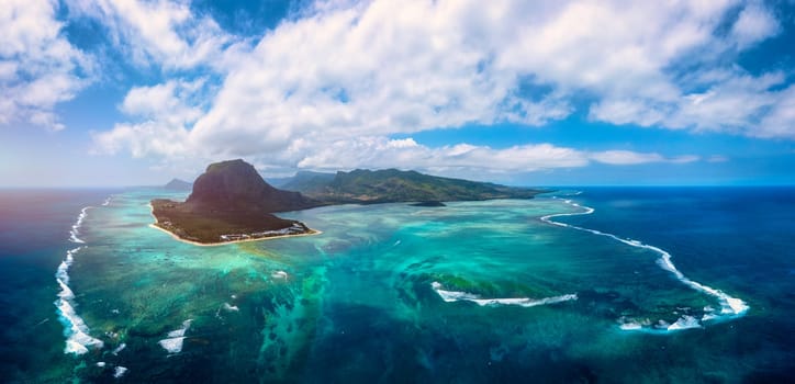 Aerial view of Mauritius island panorama and famous Le Morne Brabant mountain, beautiful blue lagoon and underwater waterfall. Le Morne Brabant peninsula and Underwater Waterfall, Mauritius.