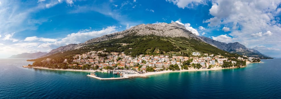 Beautiful Brela on Makarska riviera, Croatia. Adriatic Sea with amazing turquoise clean water and white sand. Aerial view of Brela town and waterfront on Makarska riviera, Dalmatia region of Croatia.