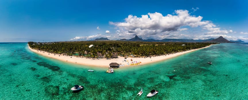 Beautiful Mauritius Island with gorgeous beach Flic en Flac, aerial view from drone. Mauritius, Black River, Flic-en-Flac view of oceanside village beach and luxurious hotel in summer.