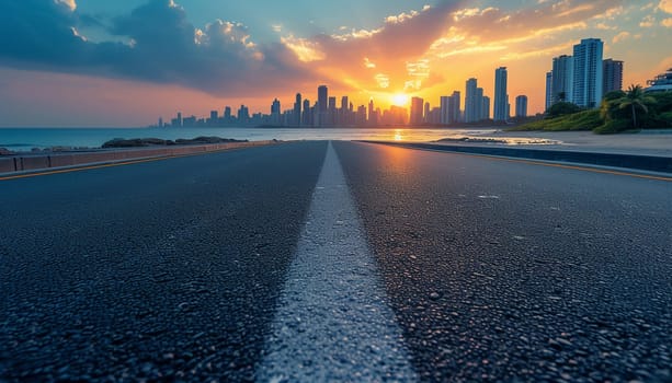 The perspective of the road against the background of sunset and the cityscape. High quality photo