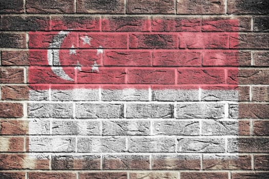 A Singapore flag on old brick wall background red white stripes crescent moon five stars white