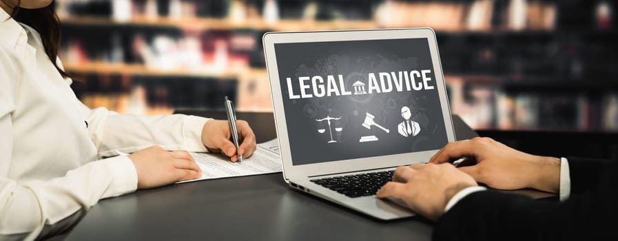 Smart legal advice website for people searching for savvy law knowledge in laptop computer on a desk in library of university or college